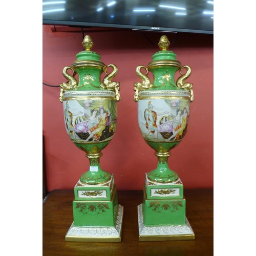 22 - A pair of Italian style green porcelain and gilt vases and covers, decorated with romantic scenes