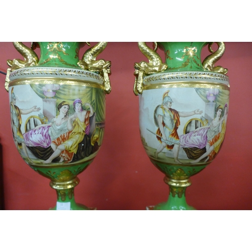 22 - A pair of Italian style green porcelain and gilt vases and covers, decorated with romantic scenes