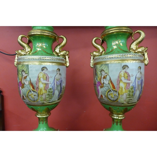 22 - A pair of Italian style green porcelain and gilt vases and covers, decorated with romantic scenes