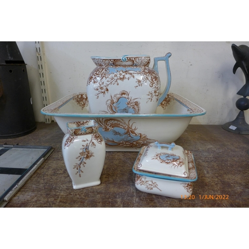 305 - A Doulton's Burslem Staffordshire porcelain wash set; jug, bowl, soap dish and brush holder