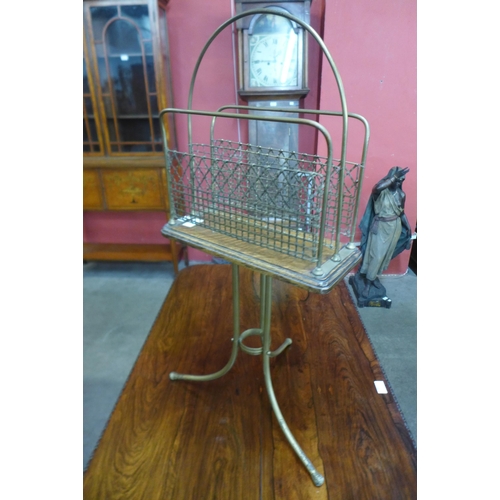 31 - A Victorian oak and brass revolving newspaper stand, base stamped Townsend