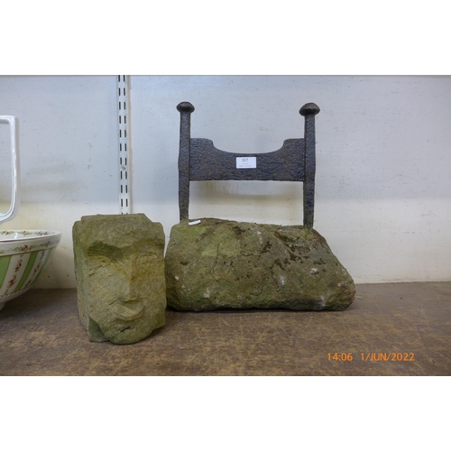 327 - A Victorian cast iron boot scraper on a stone plinth and a carved stone figural head