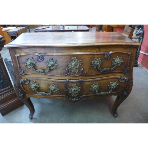 36 - An 18th Century style French provincial fruitwood bombe shaped commode