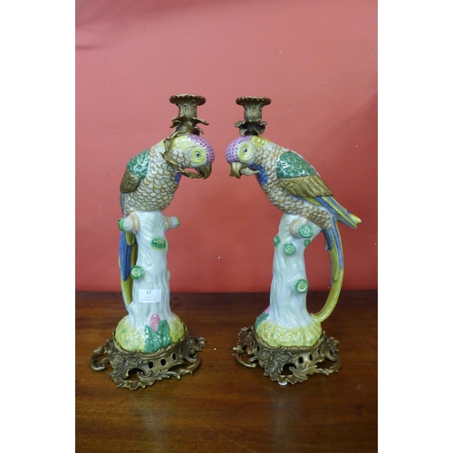 37 - A pair of French style porcelain and gilt metal mounted figural parrot candlesticks