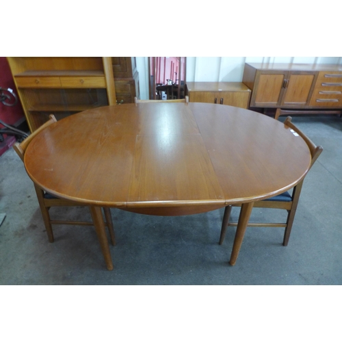 44 - A teak extending dining table and four chairs