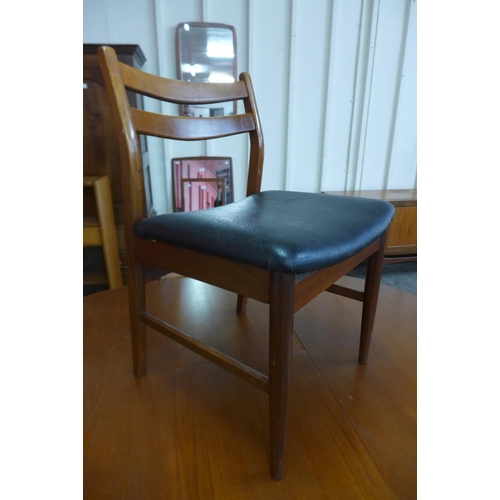 44 - A teak extending dining table and four chairs