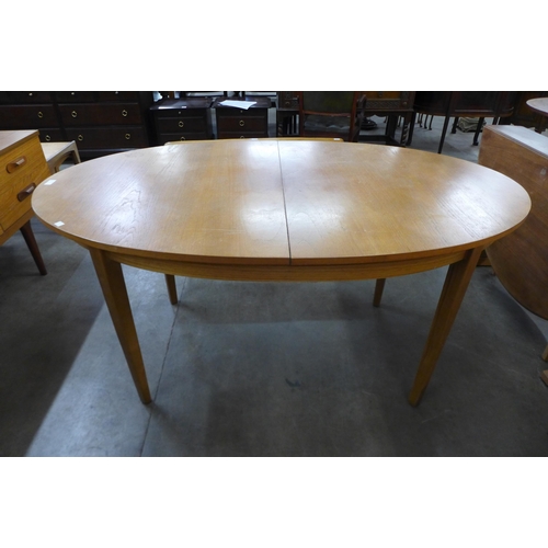 59 - An oval teak extending dining table