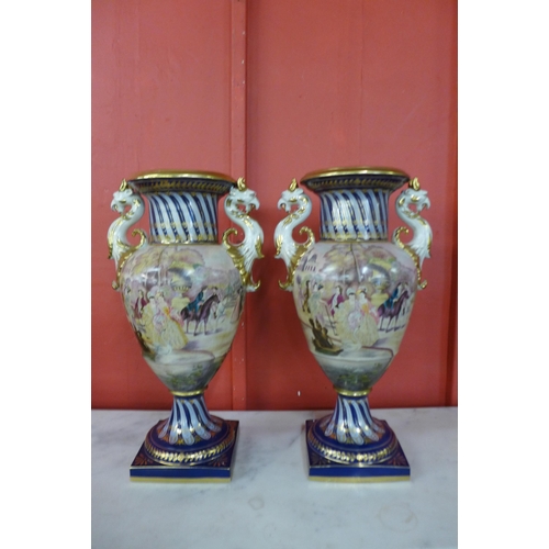 6 - A pair of large Italian style cobalt blue and gilt porcelain vases, decorated with Venetian scenes