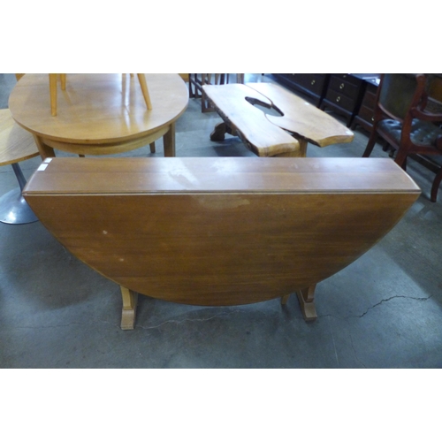 62 - An elm and beech drop-leaf dining table