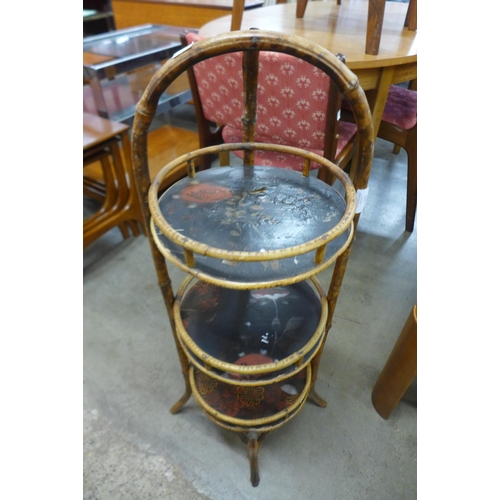 105 - A Victorian bamboo and black chinoiserie decorated three tier plant stand