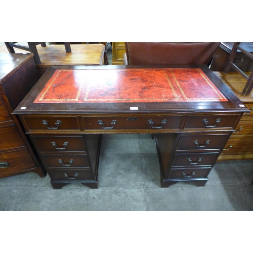 111 - A mahogany and red leather topped pedestal desk