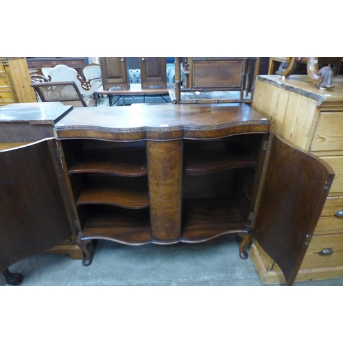 113 - An early 20th Century figured walnut serpentine side cabinet