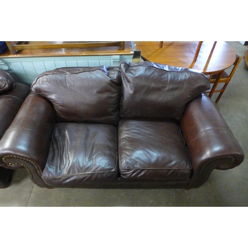 121 - A pair of brown leather settees