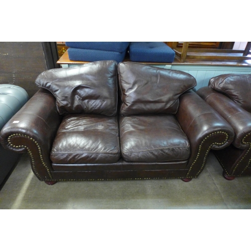 121 - A pair of brown leather settees