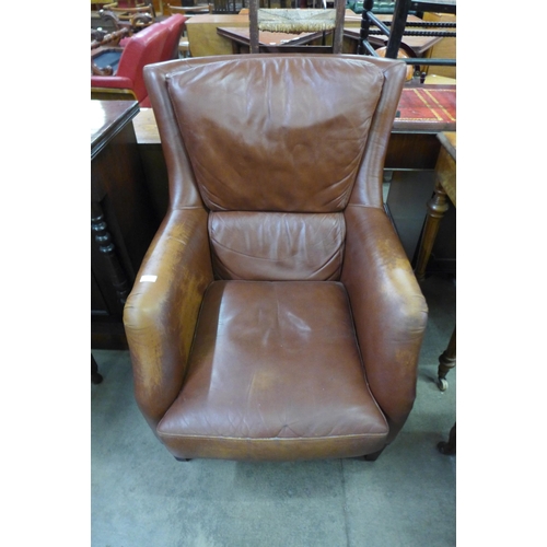 139 - A mahogany and tan leather armchair