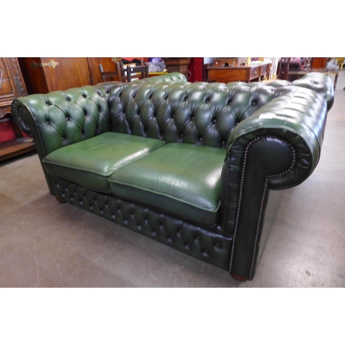 14 - A green leather Chesterfield settee