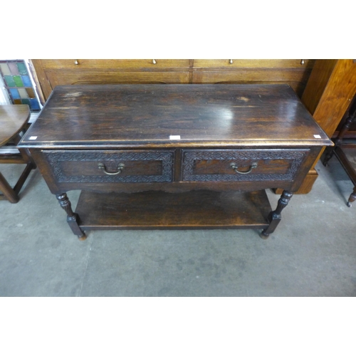 192 - A 17th Century style carved oak two drawer dresser