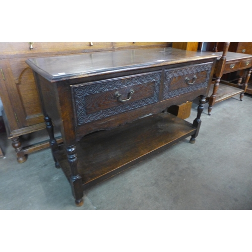 192 - A 17th Century style carved oak two drawer dresser