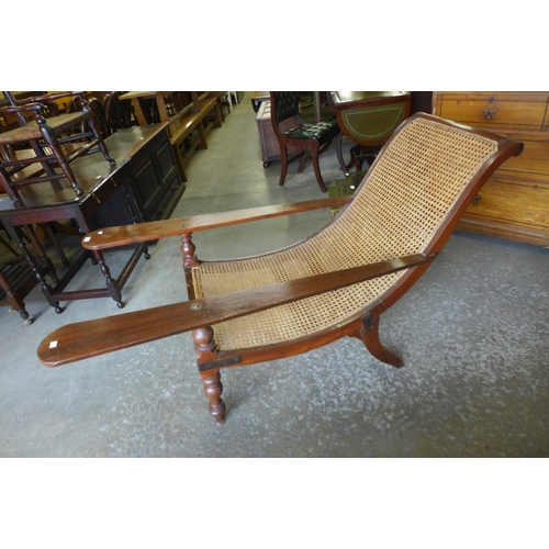 195 - An Anglo Indian teak and rattan plantation chair