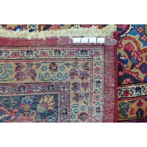 199 - A large eastern red ground rug, 376 x 299cms