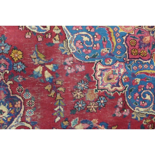 199 - A large eastern red ground rug, 376 x 299cms