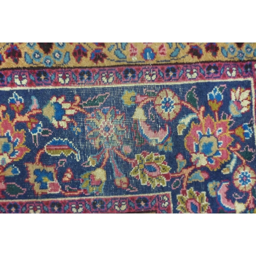 199 - A large eastern red ground rug, 376 x 299cms