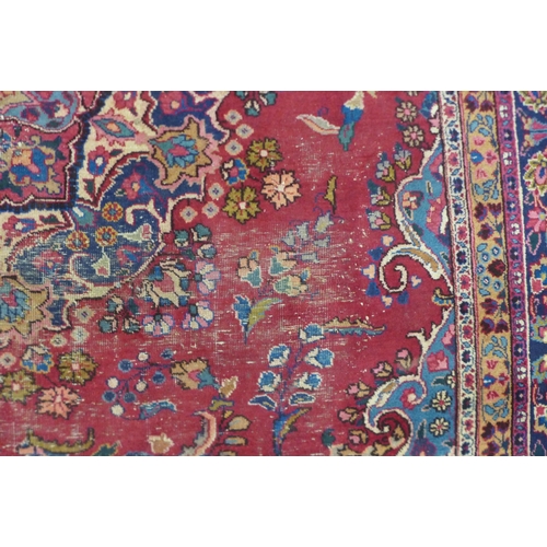 199 - A large eastern red ground rug, 376 x 299cms