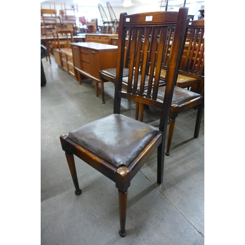 22 - A set of four Arts and Crafts walnut dining chairs