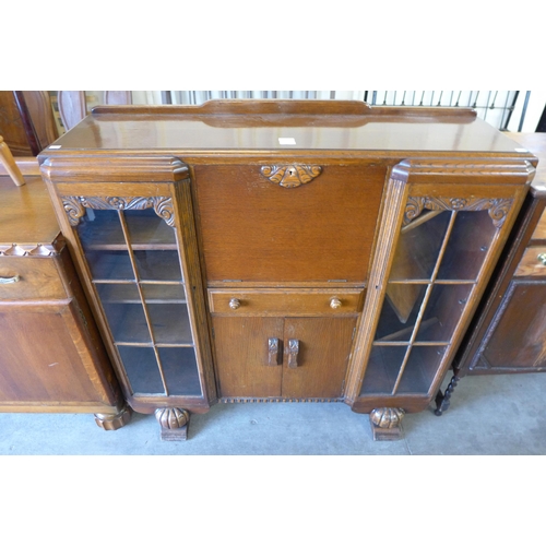 221 - A carved oak side by side bookcase