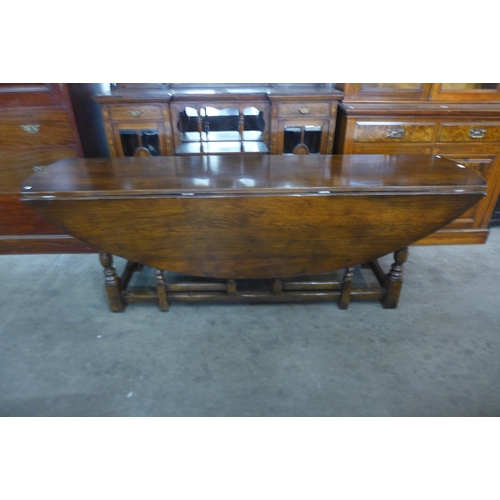 24 - A large George III style oak gateleg wake table