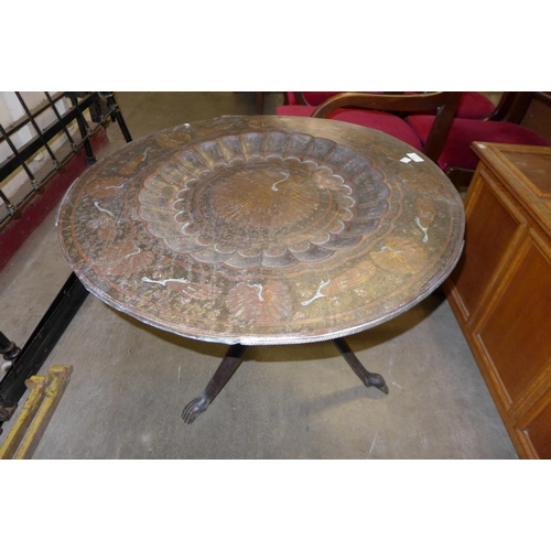 253 - An Indian brass topped folding occasional table