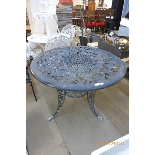 295 - A circular cast alloy garden table