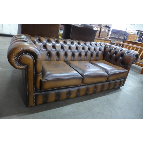 3 - A chestnut brown leather Chesterfield settee