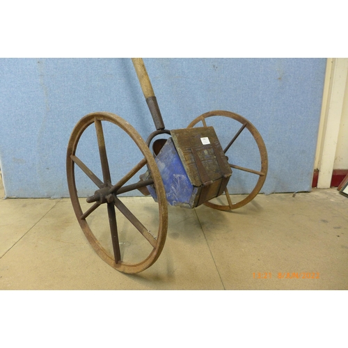 310 - An early 20th century cast iron and pine seeder