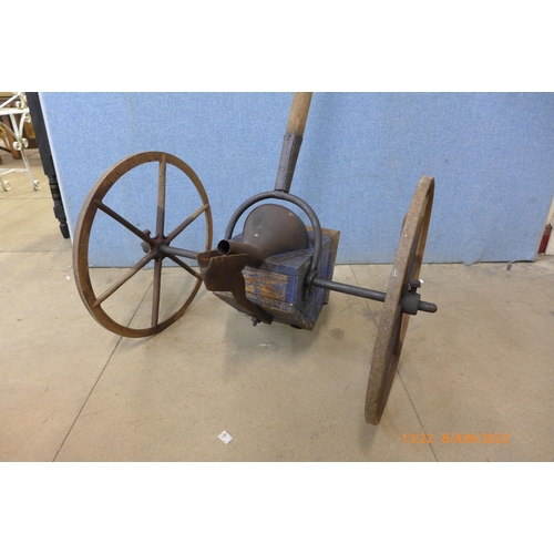 310 - An early 20th century cast iron and pine seeder