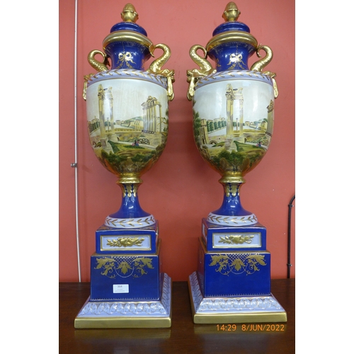 364 - A pair of large Italian style cobalt blue porcelain vases and covers, decorated with a view of St. P... 