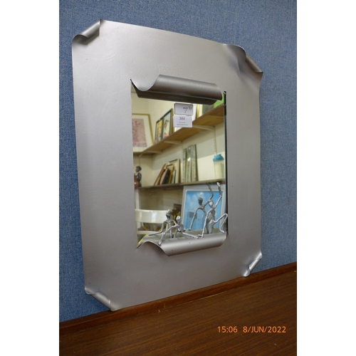 384 - A steel framed McPhail Collection mirror, by Scottish sculptor John McPhail, 50 x 38cms