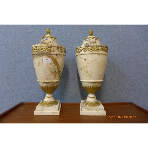 389 - A pair of Italian style marble and gilt metal mounted cassolettes