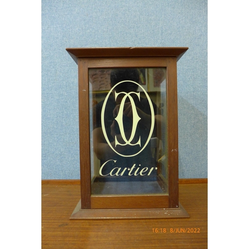 392 - An oak counter top shop cabinet, bearing Cartier inscription to door