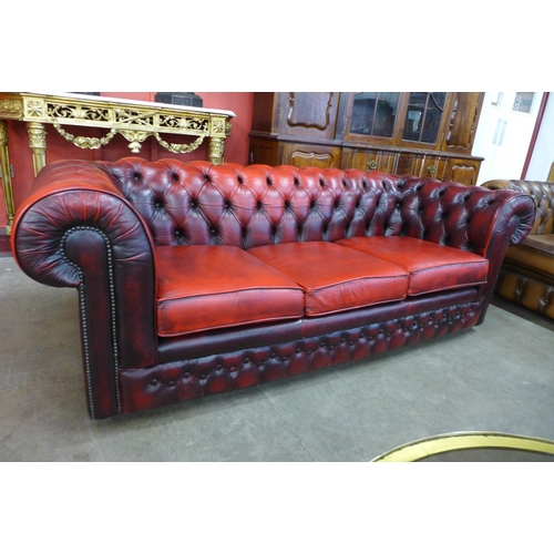 4 - An oxblood red leather Chesterfield settee