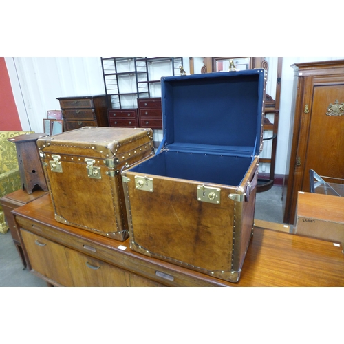 45 - A pair of chestnut brown leather and brass mounted trunks