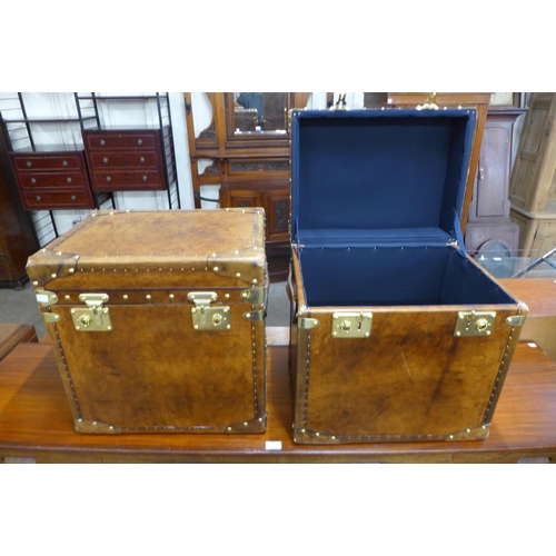 45 - A pair of chestnut brown leather and brass mounted trunks