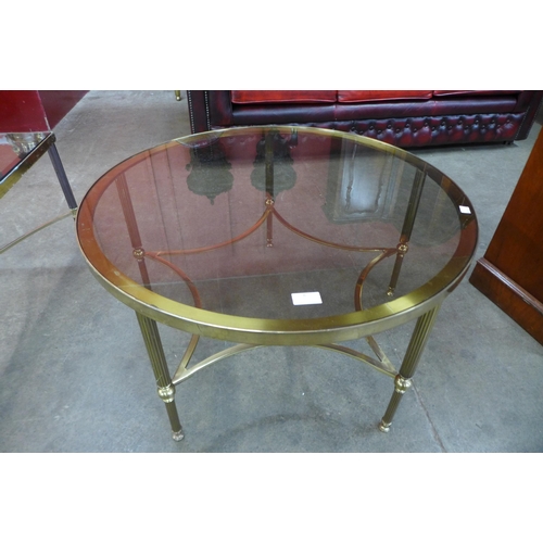 8 - An Italian brass and glass topped circular coffee table