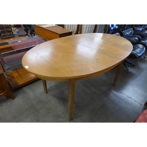 88 - A teak extending dining table