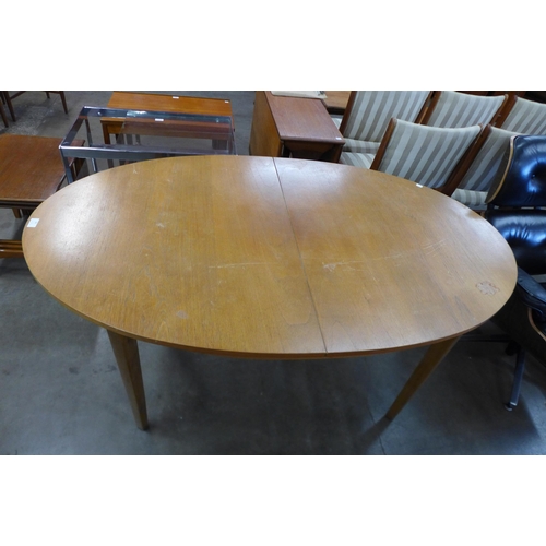 88 - A teak extending dining table