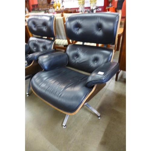 90 - A pair of Charles & Ray Eames style black leather, simulated rosewood and chrome revolving lounge ch... 