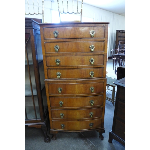 93 - A walnut bow front chest of drawers