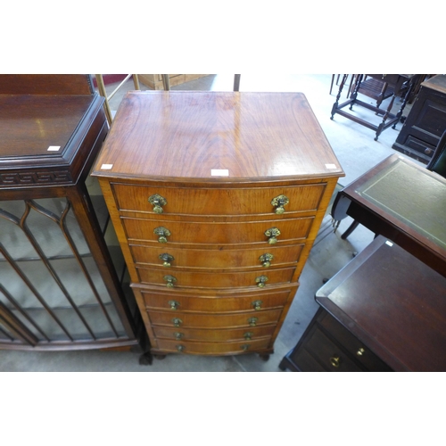 93 - A walnut bow front chest of drawers