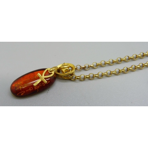 1035 - An Egyptian amber and 9ct gold pendant and chain, 5.4g