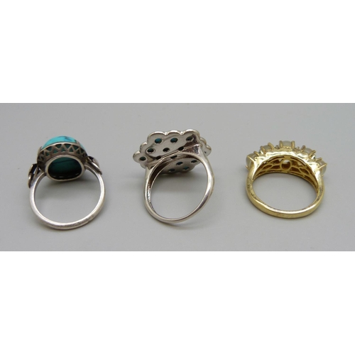 1045 - A silver and moonstone ring and two silver and turquoise rings